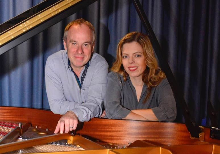 andrew and zrinka bottrell leaning over a grand piano