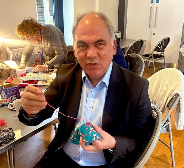 bambos charalambous darning a childs sock at bounds green repair event